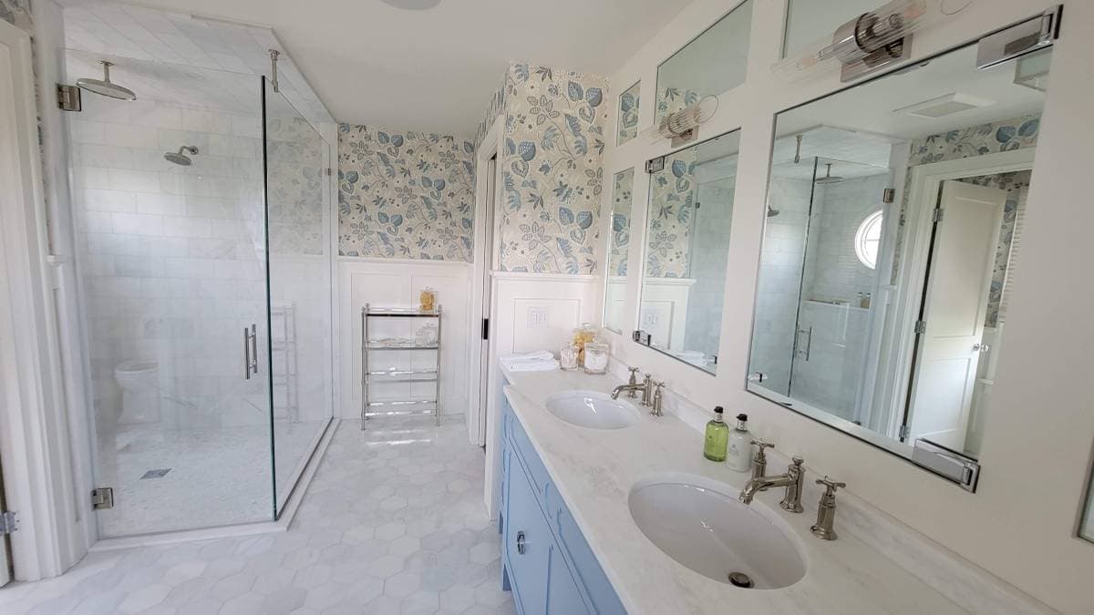 picture of a luxury bathroom with granite dual sinks and custom wallpaper